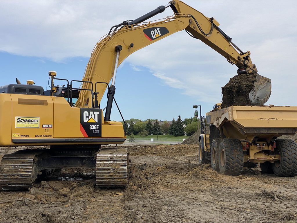 schneider-CAT-336F unloading into a dump truck